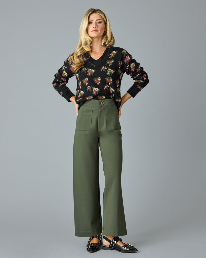 Woman in a pair of green, cropped trousers