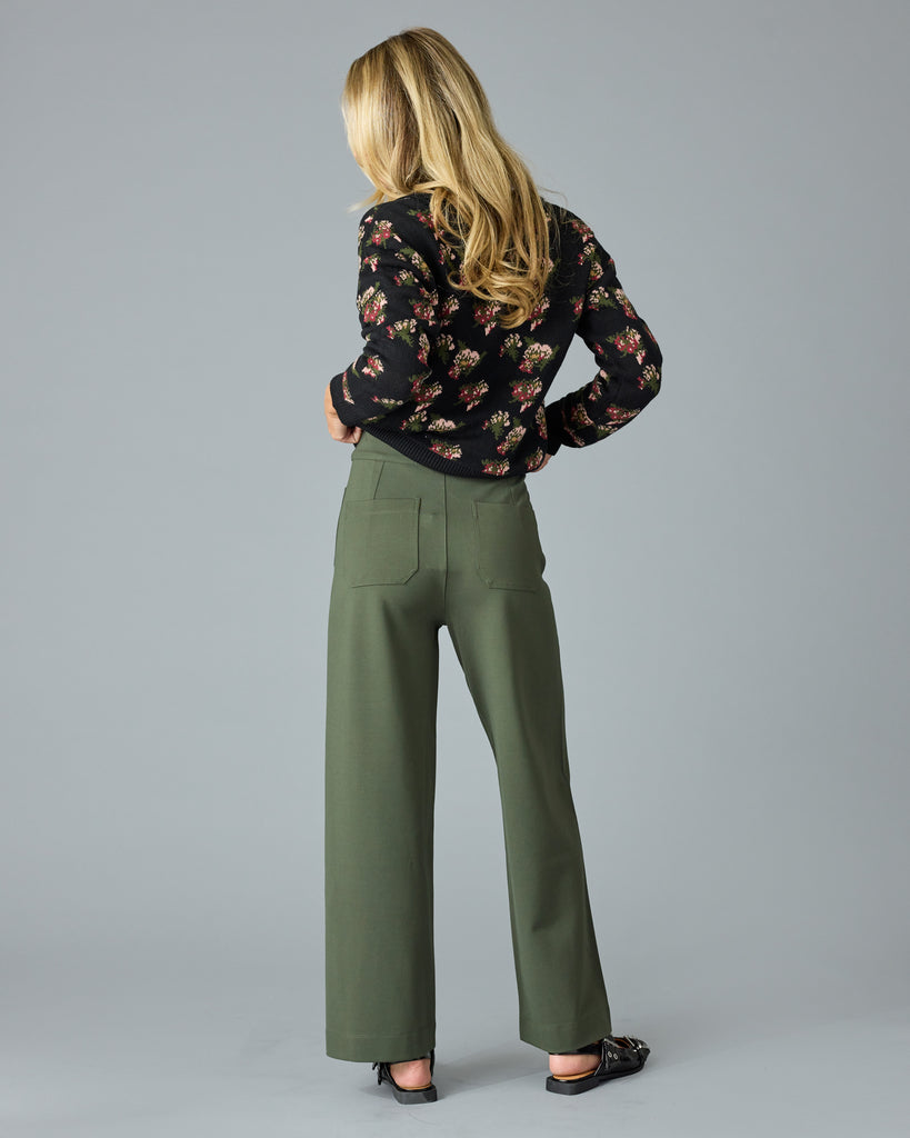 Woman in a pair of green, cropped trousers