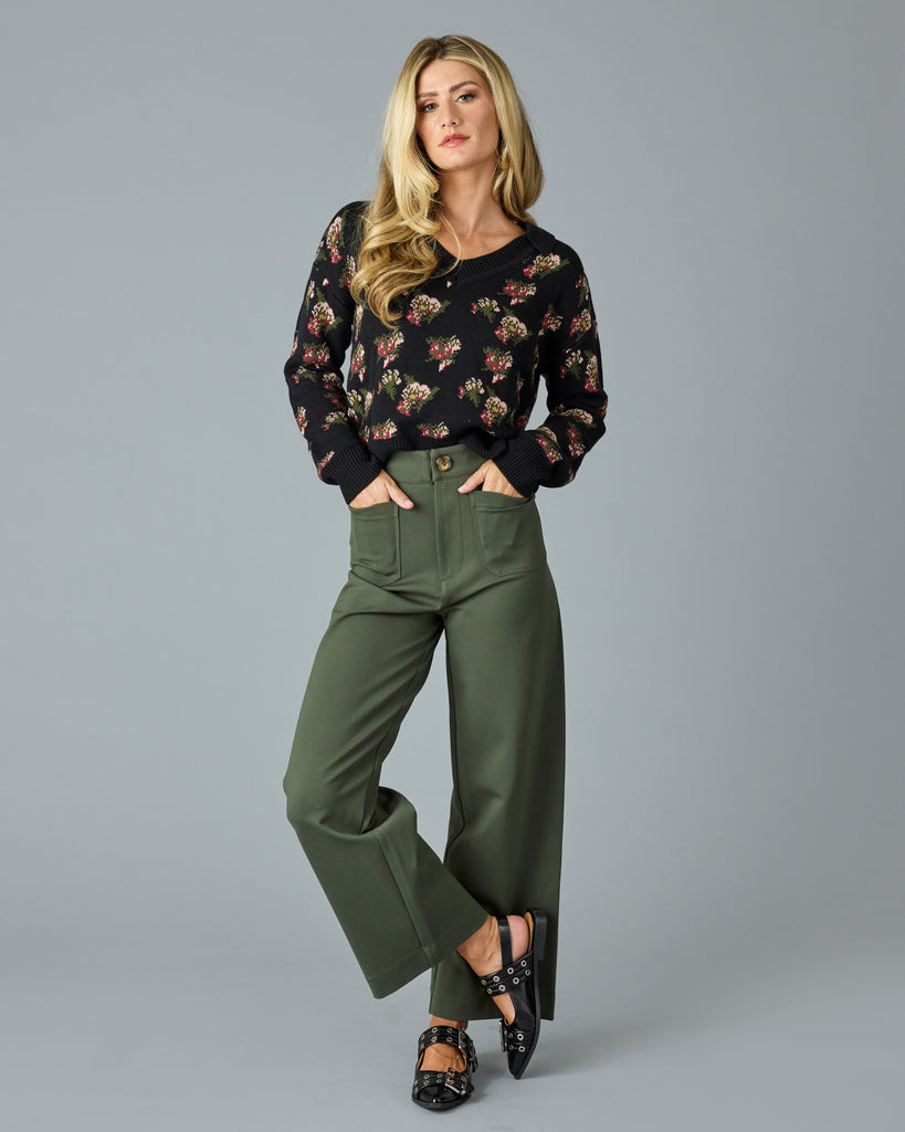 Woman in a pair of green, cropped trousers