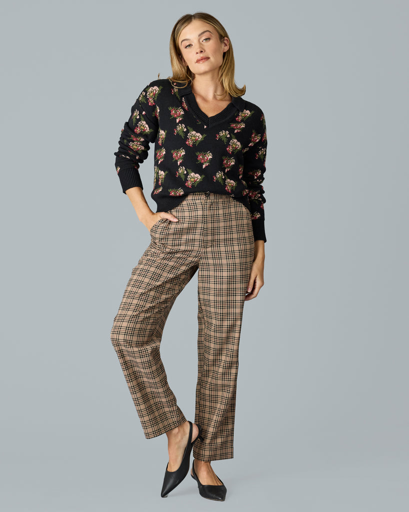 Woman in tan and red plaid trousers