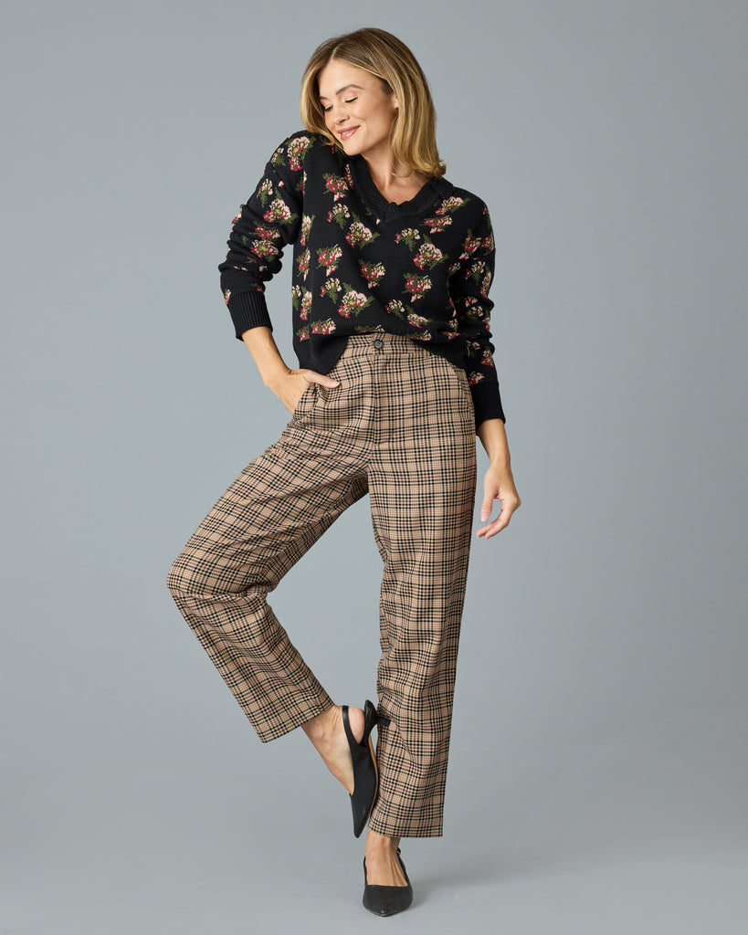 Woman in tan and red plaid trousers