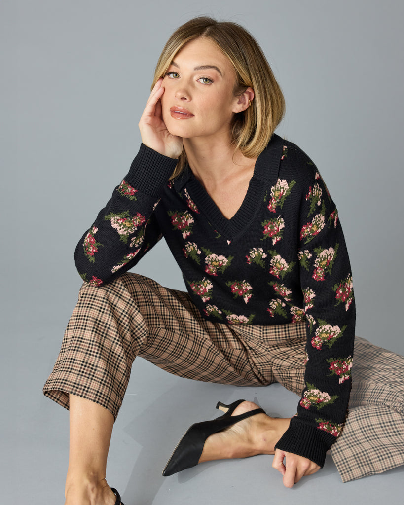 Woman in a black with floral print, long sleeve, v-neck sweater