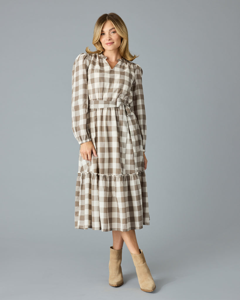 Woman in a brown plaid, long sleeve, v-neck, midi dress