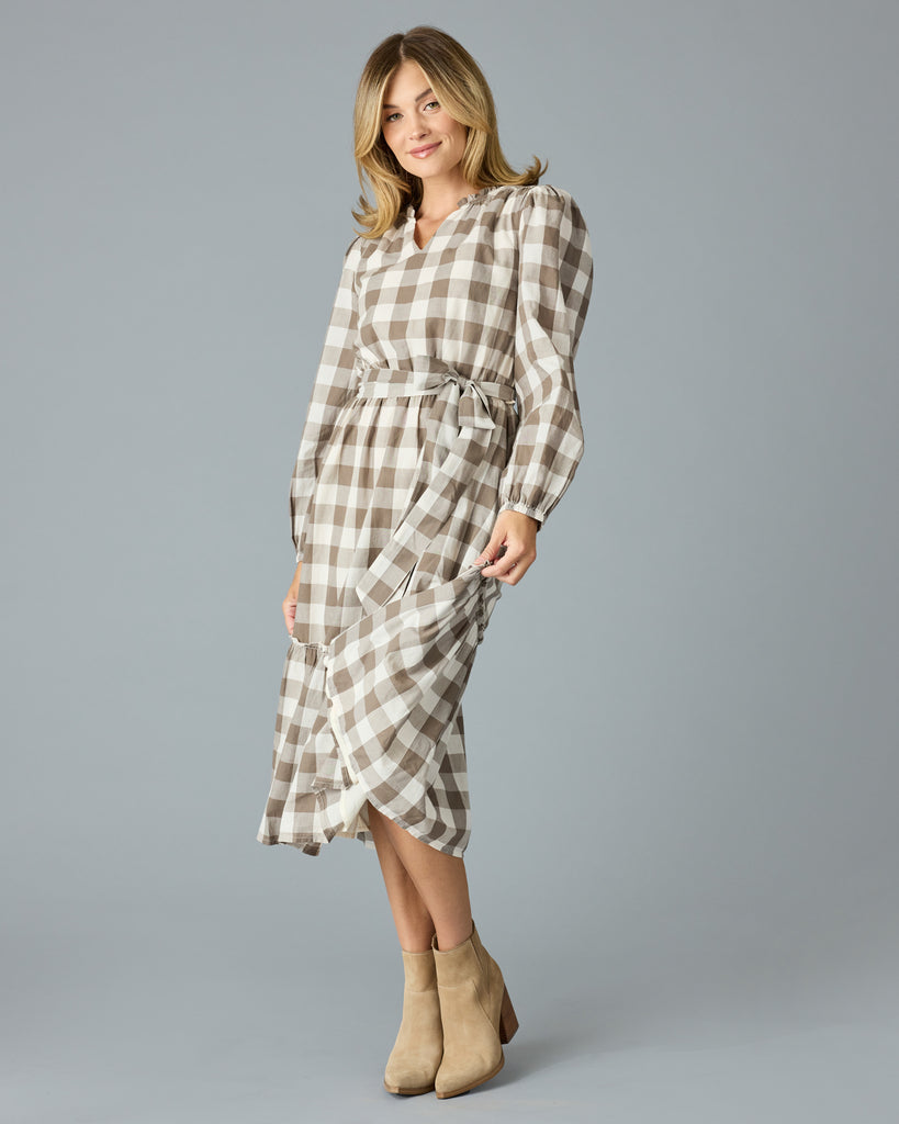 Woman in a brown plaid, long sleeve, v-neck, midi dress