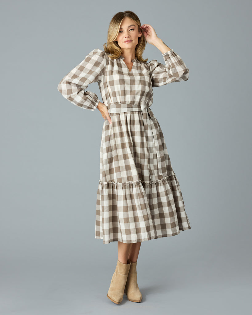 Woman in a brown plaid, long sleeve, v-neck, midi dress