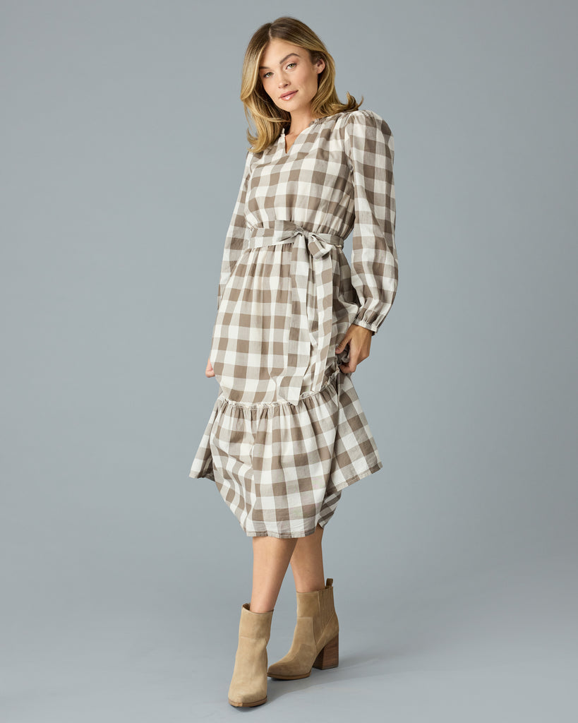 Woman in a brown plaid, long sleeve, v-neck, midi dress