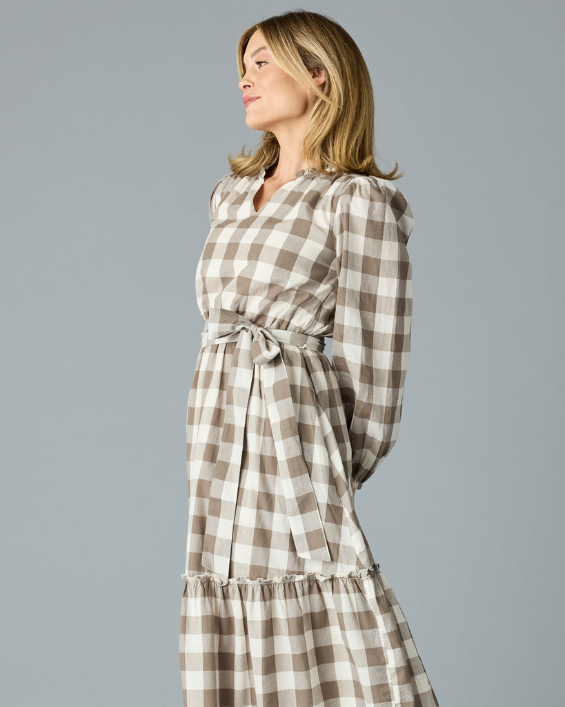 Woman in a brown plaid, long sleeve, v-neck, midi dress