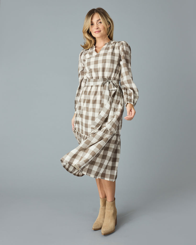 Woman in a brown plaid, long sleeve, v-neck, midi dress