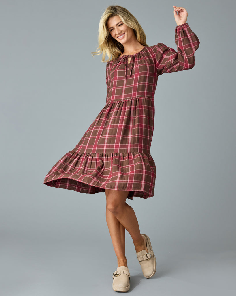 Woman in a maroon plaid, long sleeve, midi dress