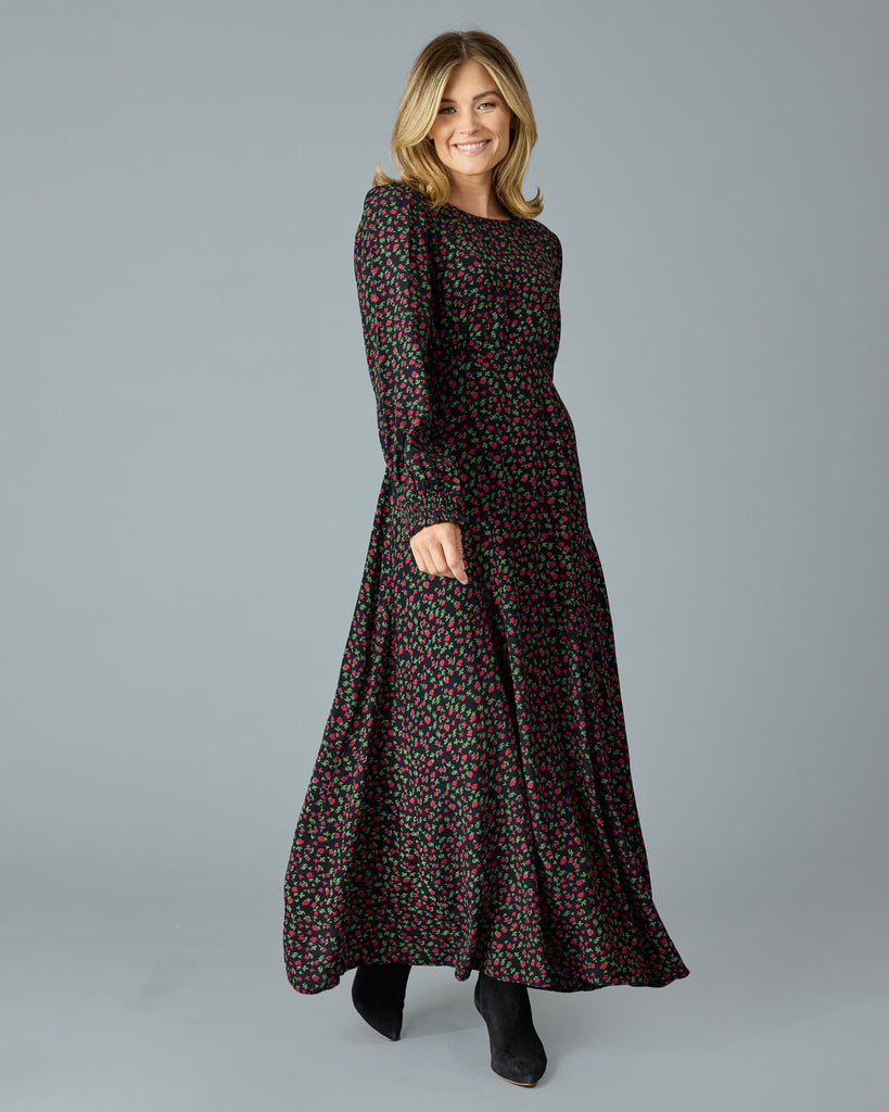 Woman in a black with floral print, long sleeve, v-neck maxi dress