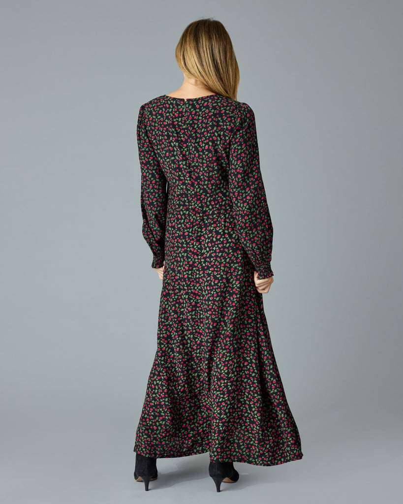 Woman in a black with floral print, long sleeve, v-neck maxi dress