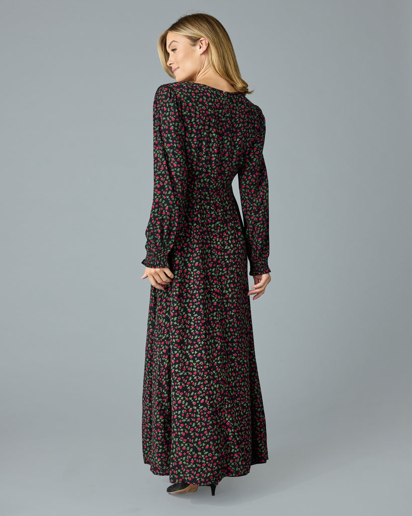 Woman in a black with floral print, long sleeve, v-neck maxi dress