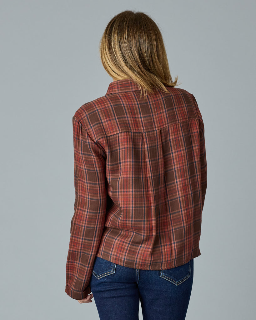 Woman in a red and brown plaid buttondown top