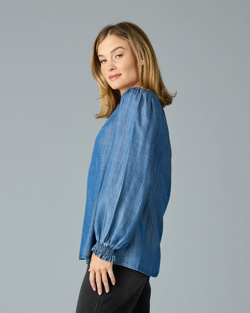 Woman in a long sleeve, dark chambray top