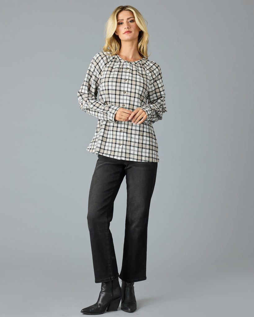 Woman in a black and white plaid long sleeve blouse