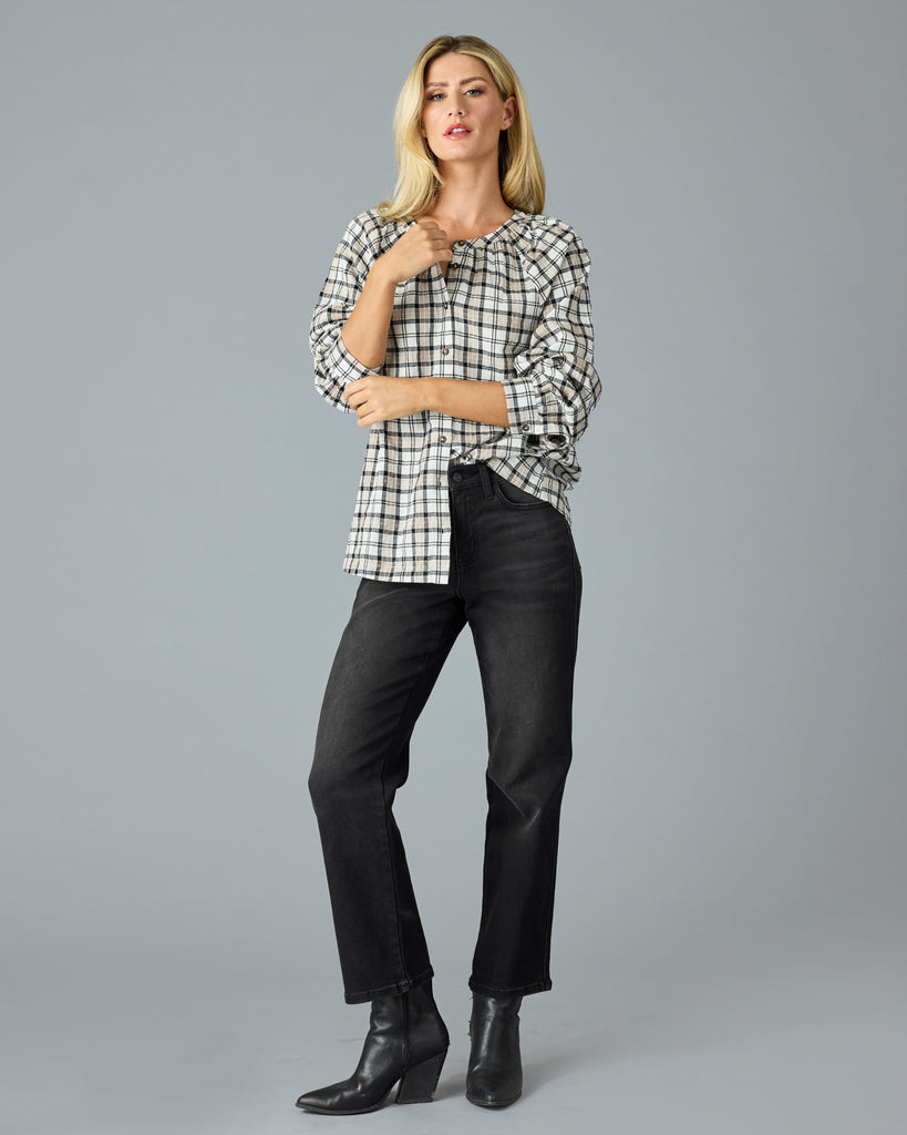 Woman in a black and white plaid long sleeve blouse