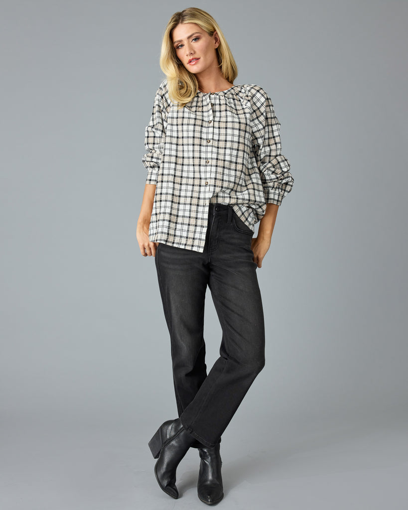 Woman in a black and white plaid long sleeve blouse