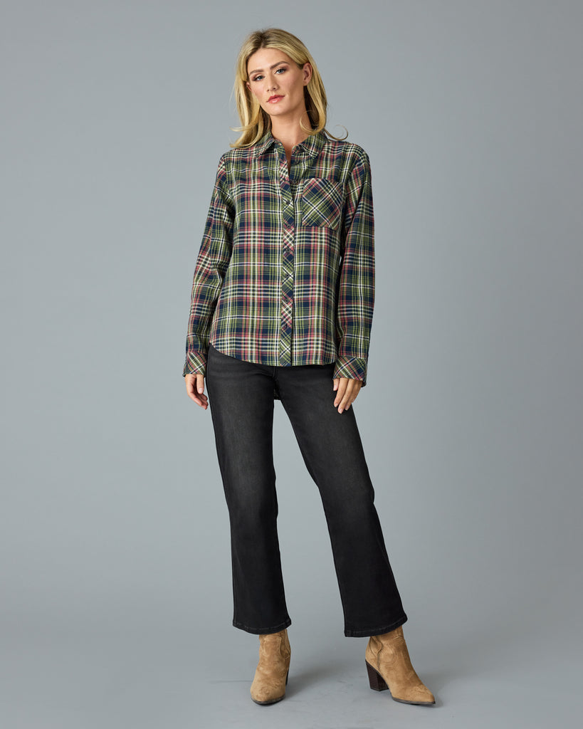 Woman in a green and pink plaid long sleeve buttondown top