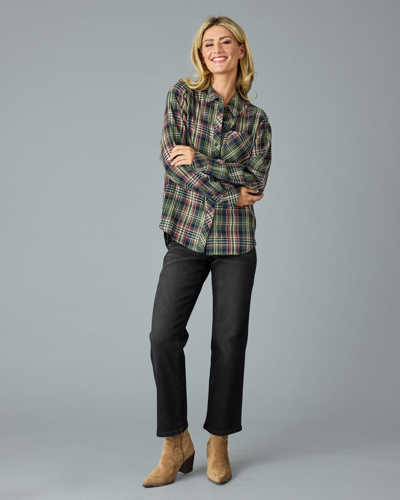 Woman in a green and pink plaid long sleeve buttondown top