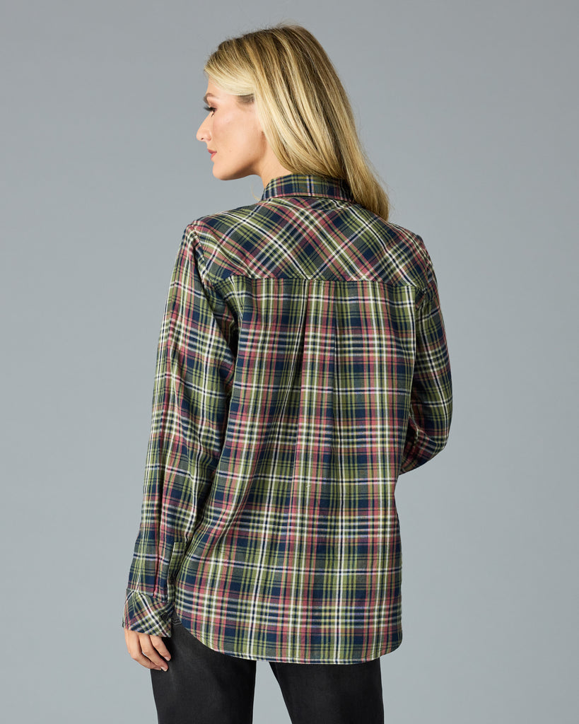 Woman in a green and pink plaid long sleeve buttondown top