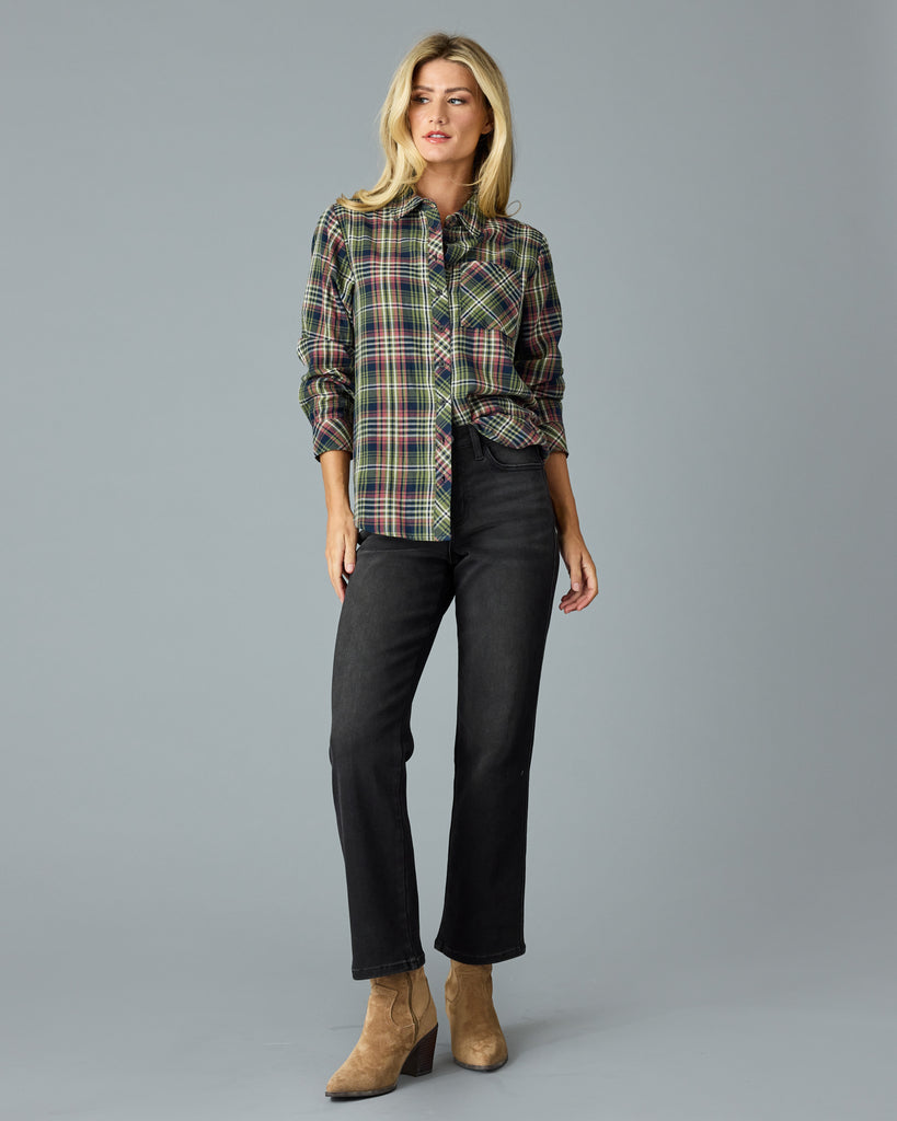 Woman in a green and pink plaid long sleeve buttondown top