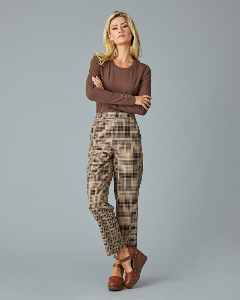 Woman in tan and red plaid trousers