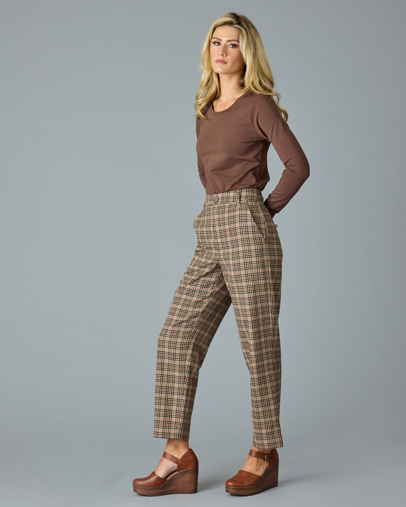 Woman in tan and red plaid trousers