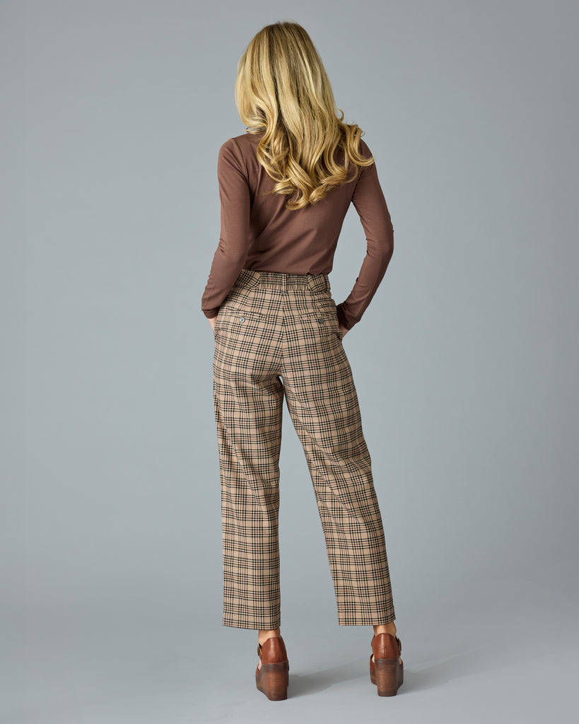 Woman in tan and red plaid trousers