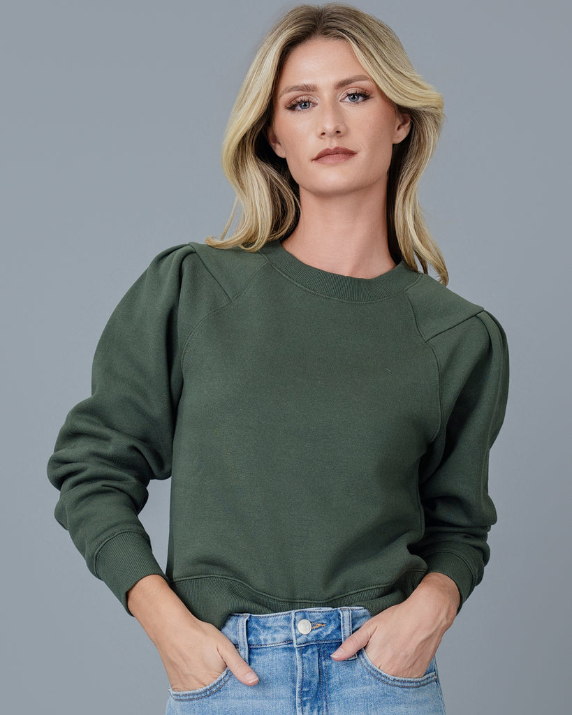 Woman in a green crew neck sweatshirt