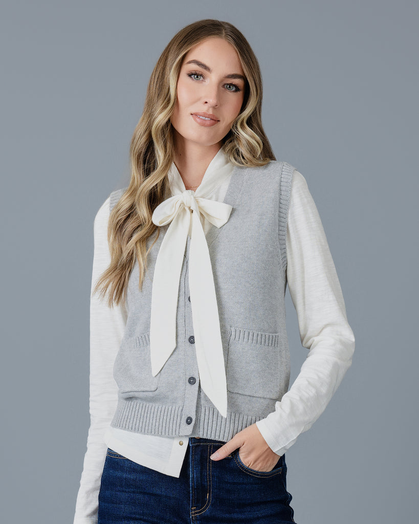 Woman in a grey cardigan vest 