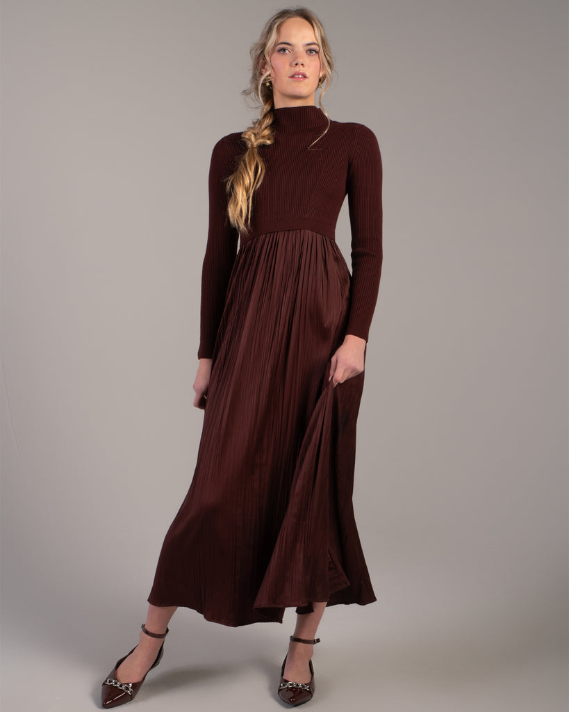 Woman in a brown long sleeve maxi length dress