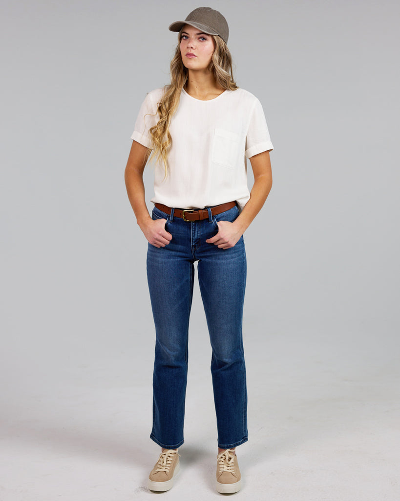 Model wearing a white short sleeve with cuff, round neck loose fitting blouse.