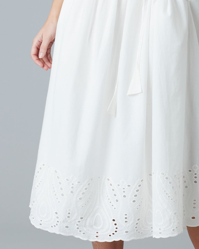 Woman in a white short sleeve midi-length dress