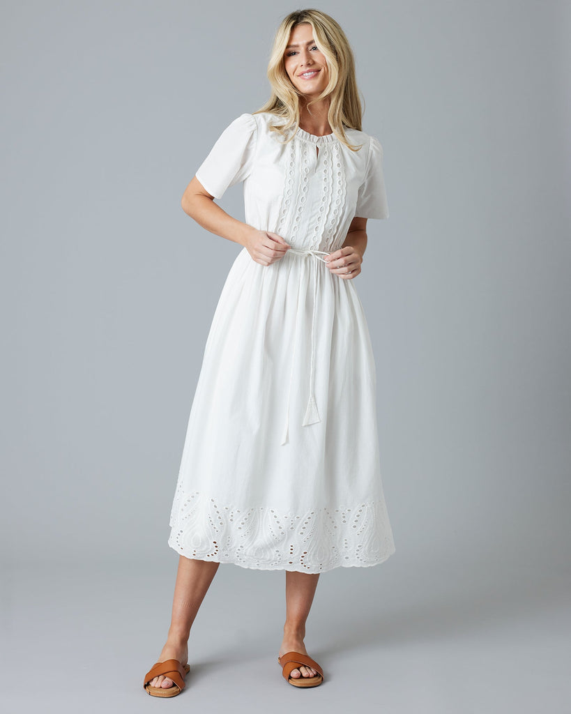 Woman in a white short sleeve midi-length dress