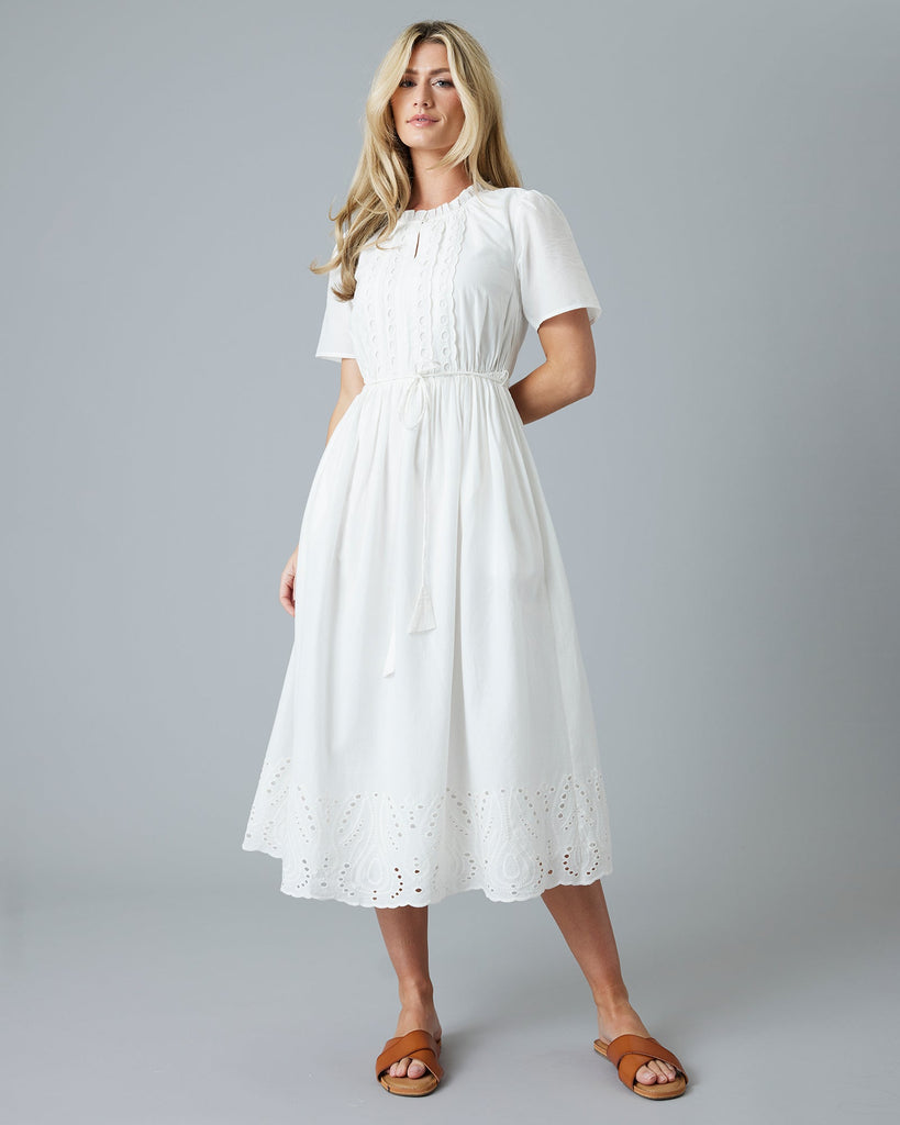 Woman in a white short sleeve midi-length dress