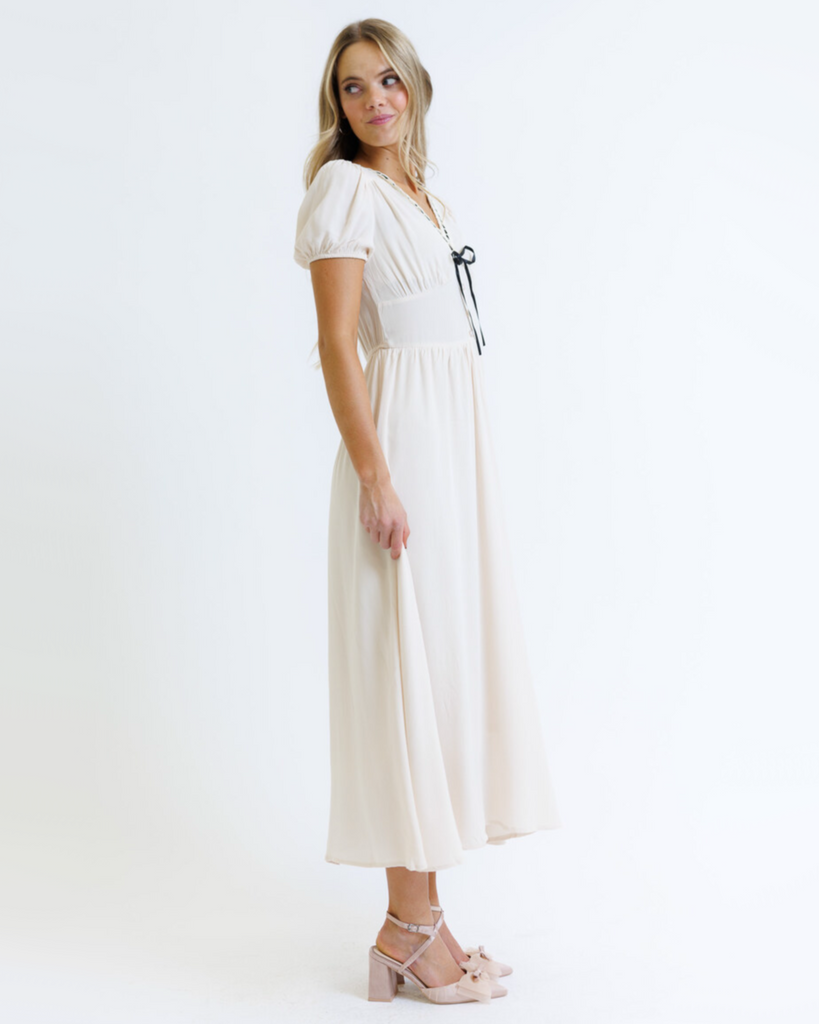 Woman wearing a white dress on a white background