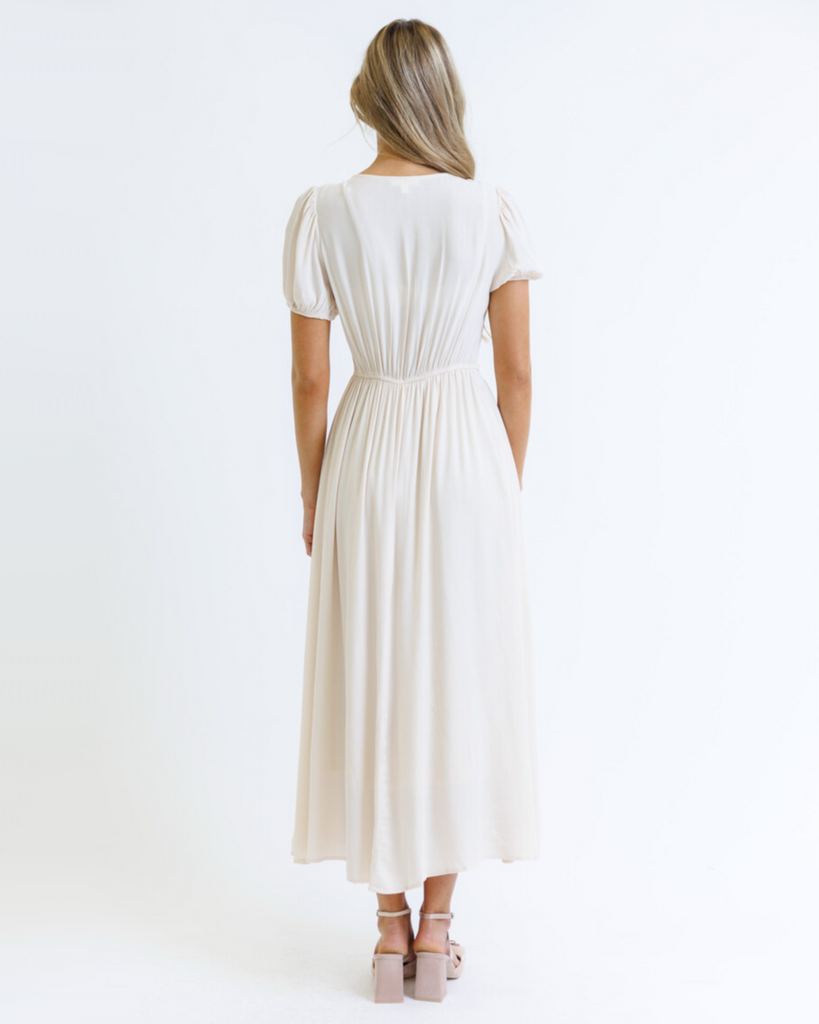 Woman wearing a white dress on a white background