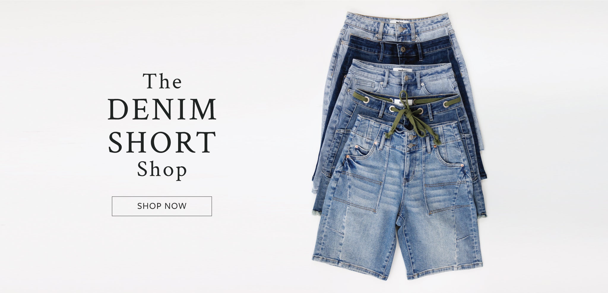 Stack of denim shorts with a 'Shop Now' button on a white background