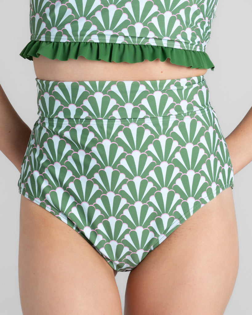 Model wearing green printed a high waisted swim bottom.