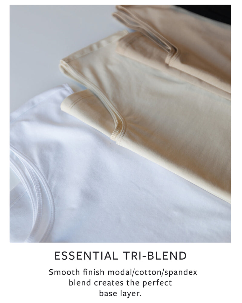 Folded beige garment on a white surface with text describing tri-blend material.