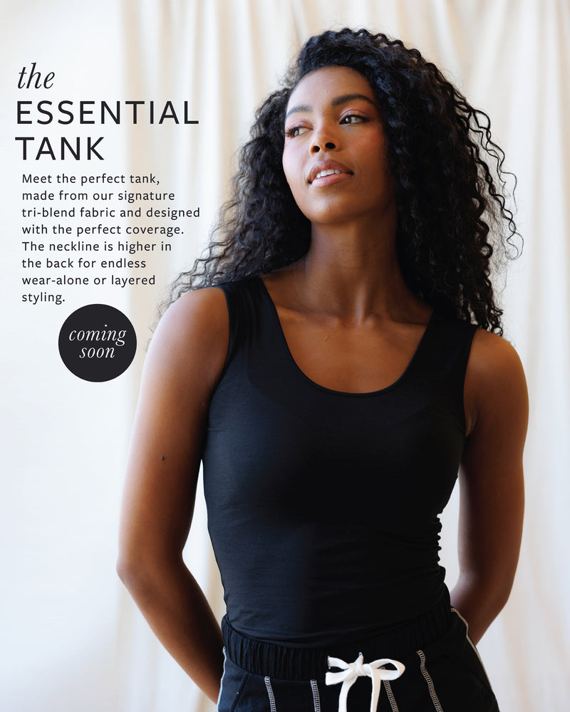 Woman wearing a black tank top with promotional text about the 'Essential Tank' on a white background.
