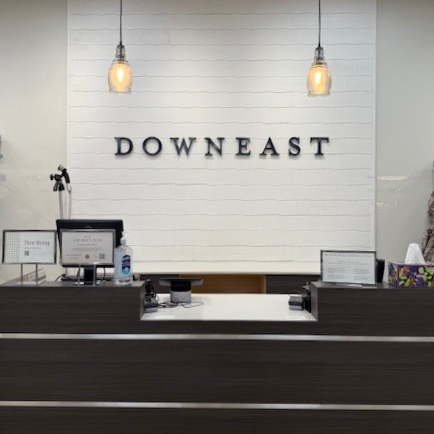 Store interior of cashier counter with 'Downeast' sign on a wall.
