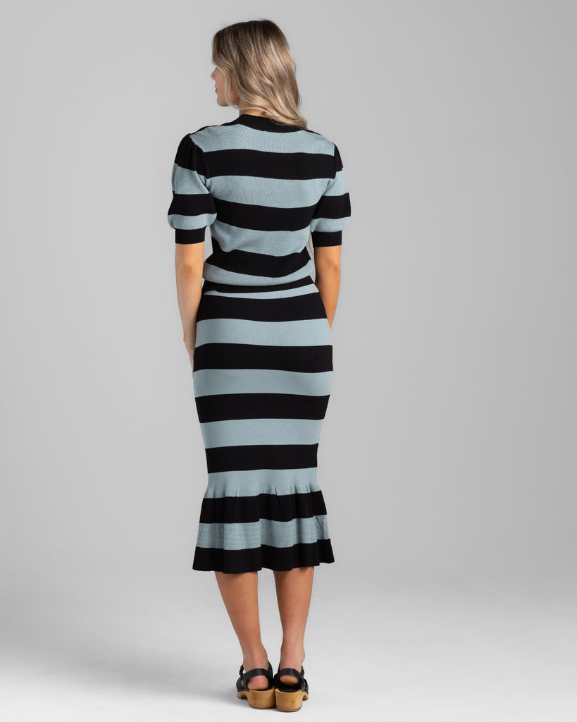 Model wearing a black and teal wide striped pencil knit midi skirt.