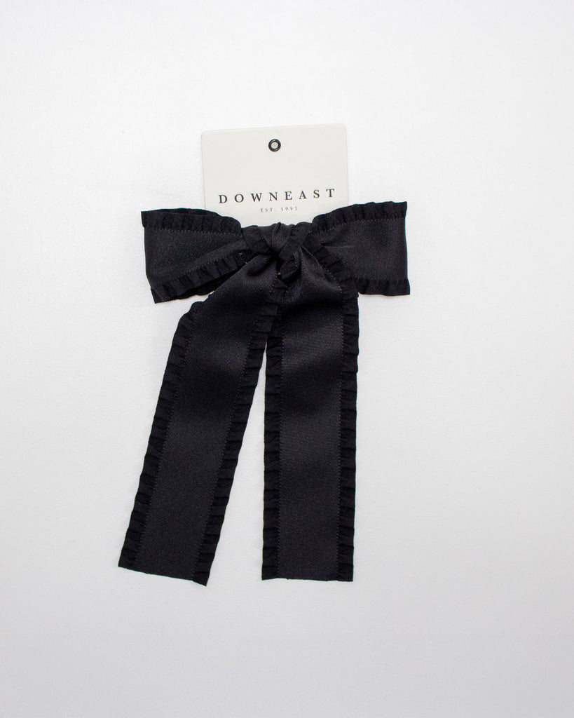 Black bow hair accessory on a white background with 'Downeast' brand label.