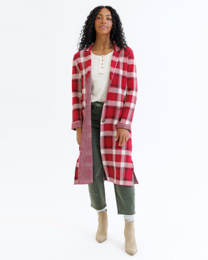 Woman wearing a red plaid coat on a white background
