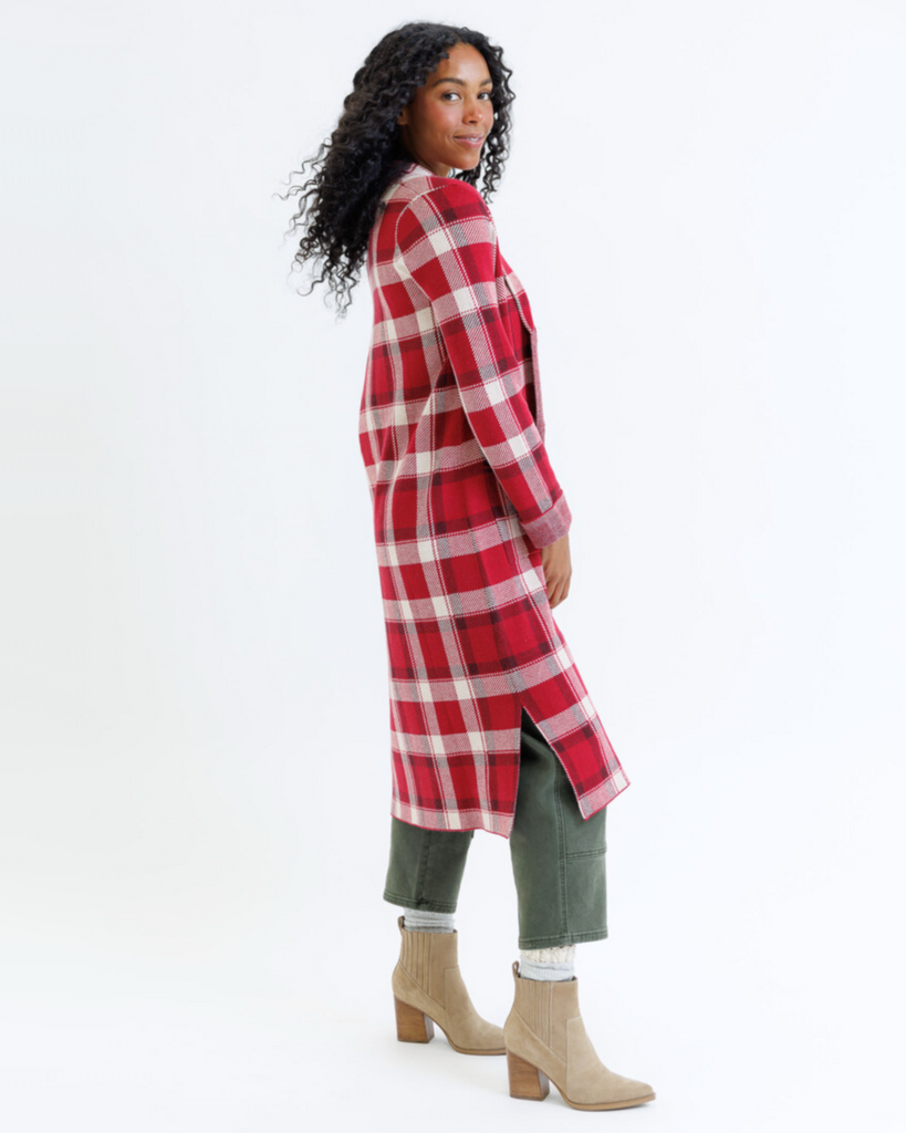 Woman wearing a red plaid coat on a white background