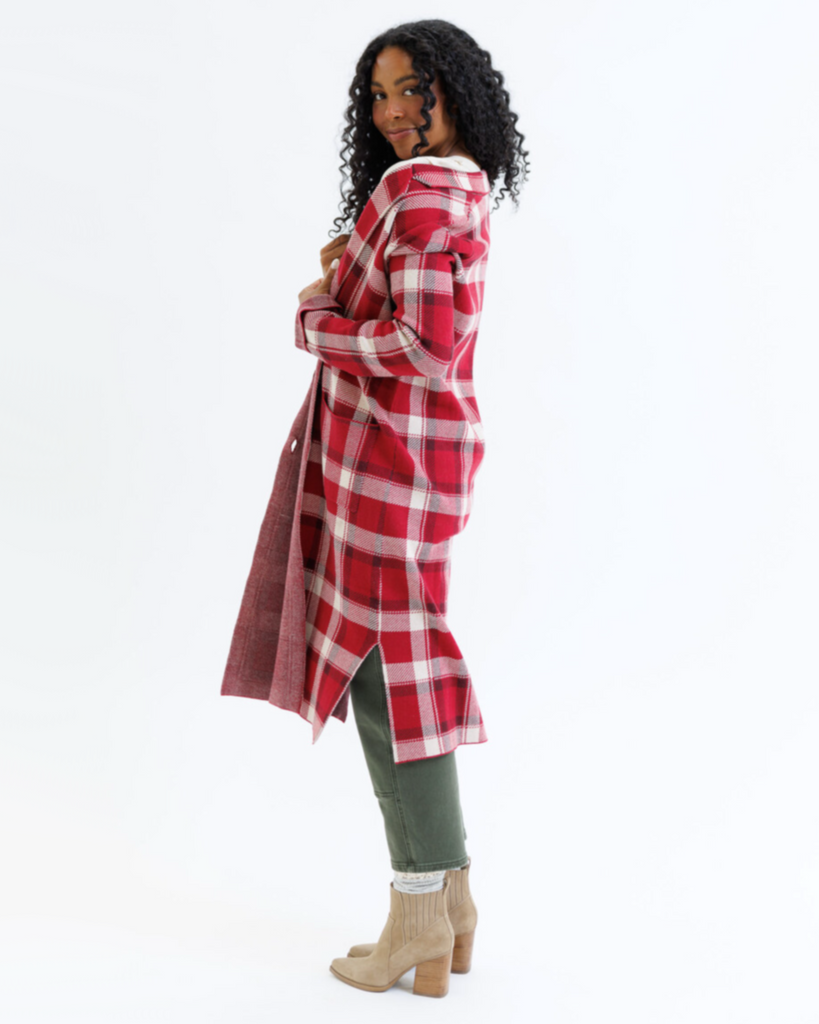 Woman wearing a red plaid coat on a white background