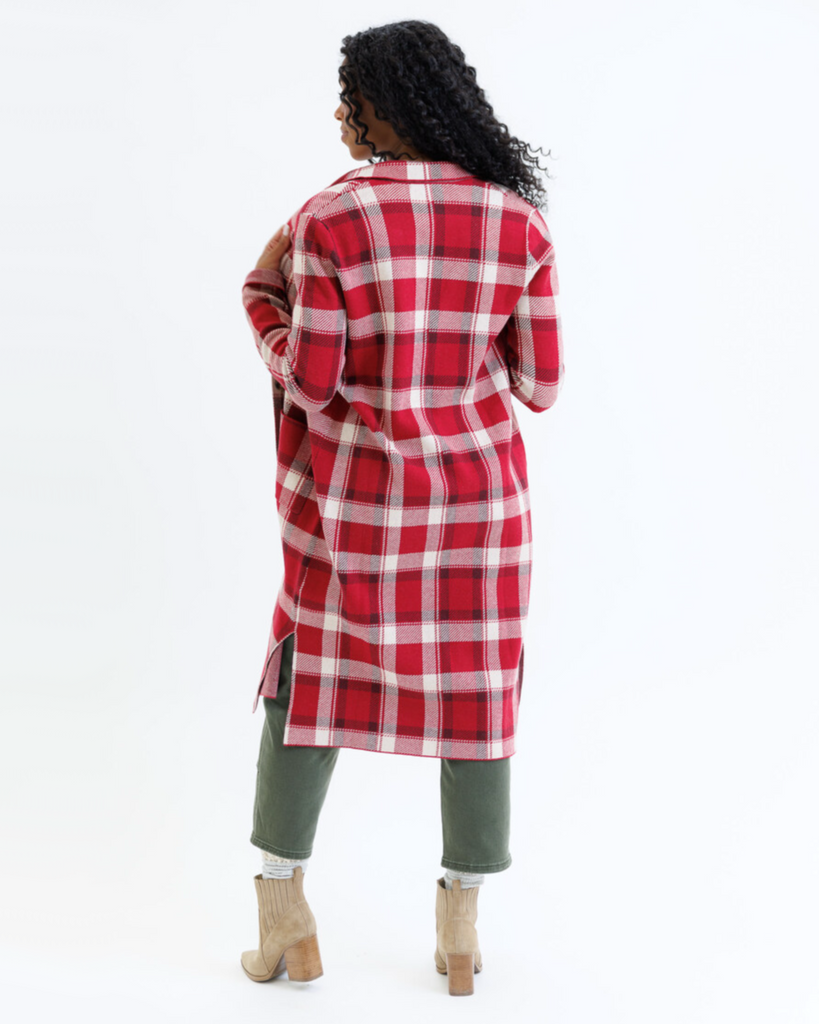Woman wearing a red plaid coat on a white background