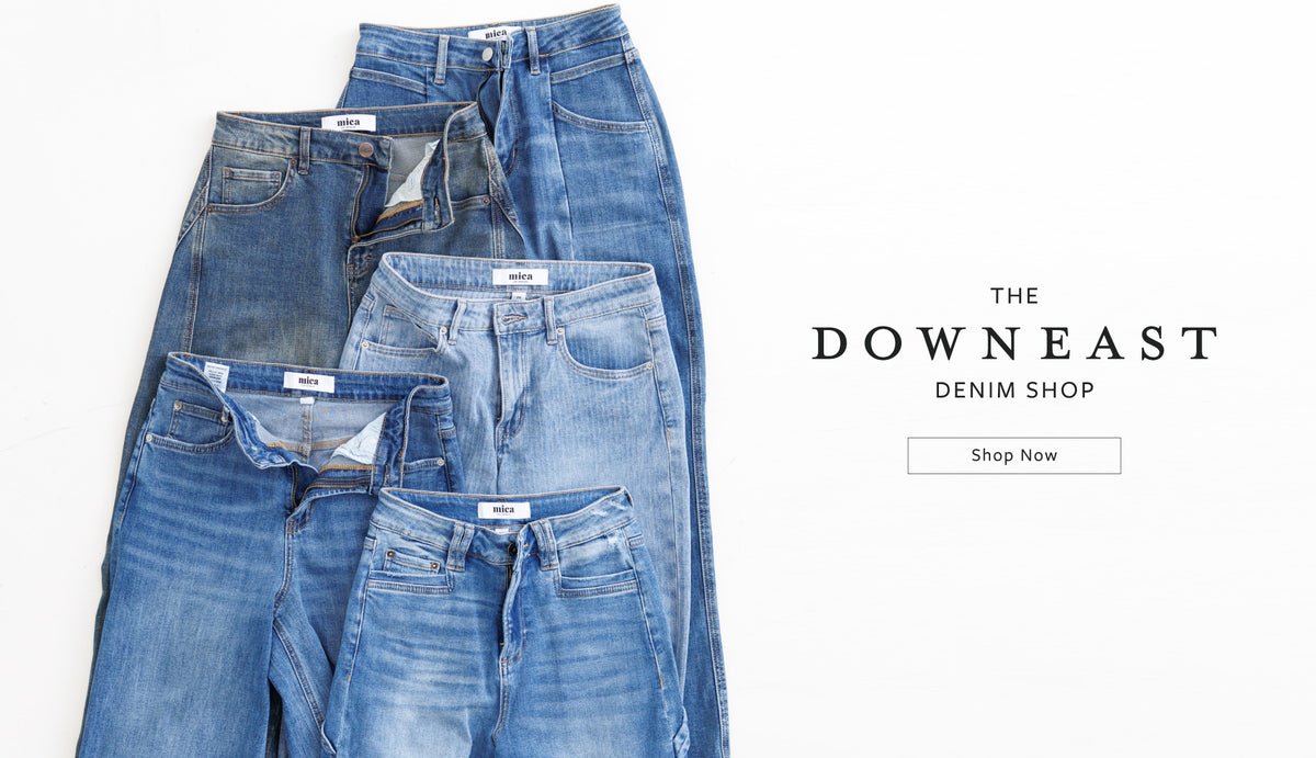 Four pairs of folded blue denim jeans in different washes and fits arranged on a white background, with the text 'THE DOWNEAST DENIM SHOP' and a 'Shop Now' button on the right.