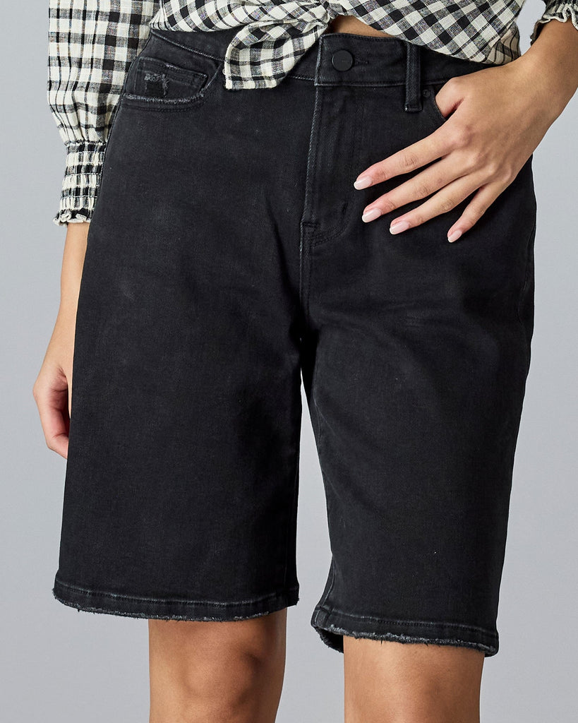 Woman in baggy bermuda shorts.